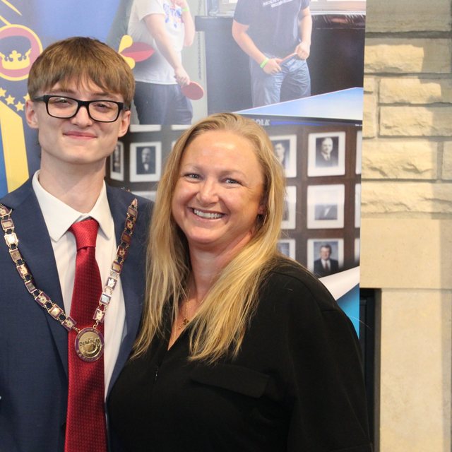 Erin smiling with Nathan, who is wearing his DeMolay chain collar